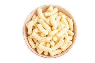 Corn flakes sticks with caramel in ceramic bowl isolated on white background. top view, flat lay,