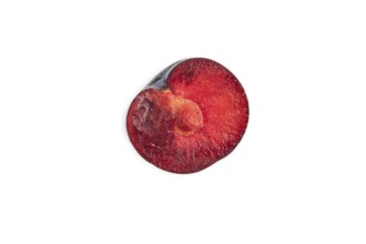 Purple Plum Cut in half isolated on white background. Top view, flat lay, copy space. healthy food,