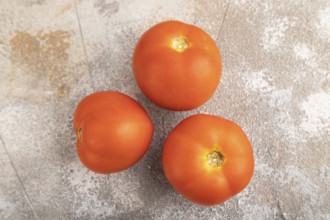 Red tomato on brown concrete background. Top view, flat lay, close up. healthy food, vegetable,