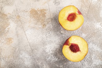 Peach Cut in half on brown concrete background. Top view, flat lay, copy space. healthy food,