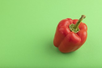 Red pepper on green pastel background. Side view, copy space. healthy food, vegetable, minimalism