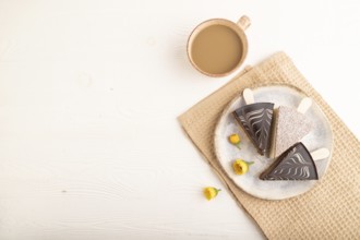 Chocolate and Vanilla Cake pops Marshmallow with cup of coffee on white wooden background and beige
