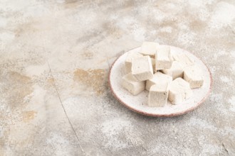Coffee marshmallow on brown concrete background. side view, copy space