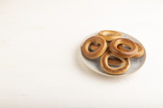 Homemade Ring Bagel on white wooden background. side view, copy space