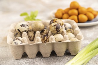 Pile of Smoked Quail eggs on plate on a brown concrete background. side view, close up, selective