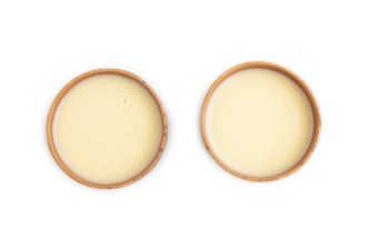 Organic non dairy banana and soy milk in clay cup isolated on white background. Vegan healthy food