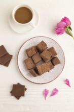 Chocolate marshmallow with cup of coffee on white wooden background. top view, flat lay, close up