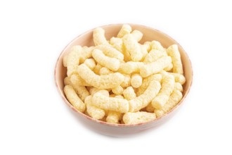 Corn flakes sticks with caramel in ceramic bowl isolated on white background. Side view, close up