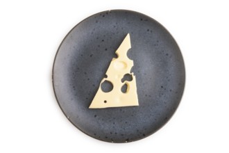 Piece of cheese with holes on blue plate isolated on white background, top view, flat lay, copy