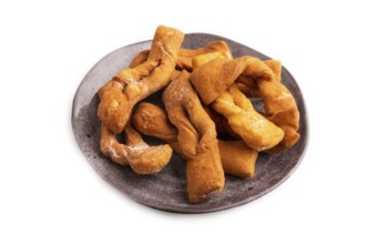 Crunchy biscuit Brushwood cookies sprinkled with powdered sugar isolated on white background, side