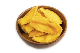 Dried Mango in wooden bowl isolated on white background. Side view, close up. healthy food,