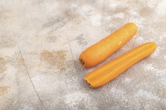 Orange Carrot on brown concrete background. Side view, copy space. healthy food, vegetable,