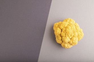 Yellow Cauliflower on black and gray pastel paper background. Top view, flat lay, copy space.
