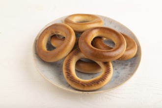 Homemade Ring Bagel on white wooden background. side view, close up