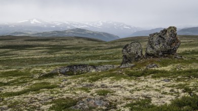 Barren plain landscape with striking rock formation under a cloudy sky, pilgrimage route Olavsweg