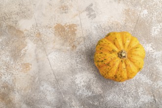 Orange Pumpkin on brown concrete background. Top view, copy space, flat lay. healthy food,