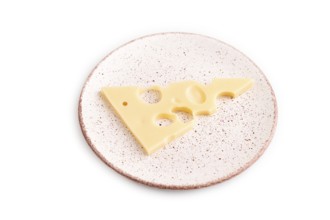 Piece of cheese with holes on plate isolated on white background, side view, copy space, minimalism