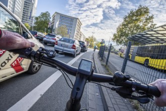 Riding a bike on a bike lane, at Essen main station, in front of Europaplatz, in the city centre of
