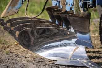 Plough, for ploughing a field, field, ploughshares, agricultural technology, shiny stainless steel,