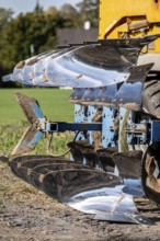 Plough, for ploughing a field, field, ploughshares, agricultural technology, shiny stainless steel,