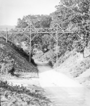Magic lantern slide of footbridge crossing the road at Wilford Hollows, Bromeswell, Suffolk,
