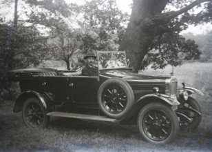 Vintage Sunbeam motor car with driver at wheel in rural setting, England, UK 1920s or 1930s