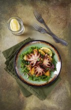Warm salad, grilled mini octopus, with potatoes and fresh herbs, homemade, no people