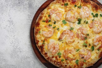 Four cheese pizza with shrimp and fresh microgreens, served on a wooden board, homemade, no people