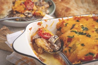 Madame Bovary's Georgian dish, chicken fillet with mushrooms, tomatoes and cheese, baked in a mold