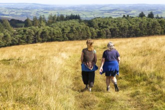 Two women, mother and daughter, walking on moorland in autumn, near Hayford, Buckfastleigh,