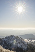 View over the hills and valleys from the mountain with hoarfrost on the branches in winter, Vápec,