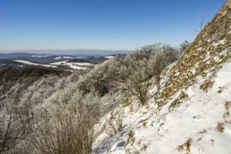 View over the hills and valleys from the mountain with hoarfrost on the branches in winter, Vápec,