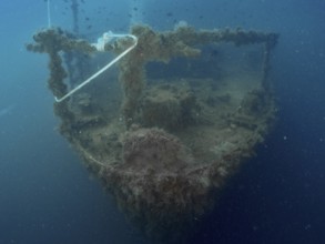 Bow of a shipwreck with rope and algae in blue water. Dive site wreck of the Vis, Pula, Croatia,