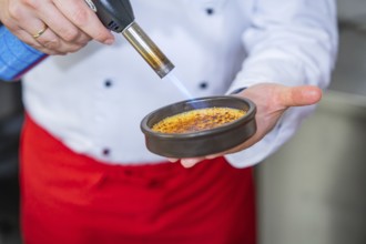Dessert is caramelised using a Bunsen burner