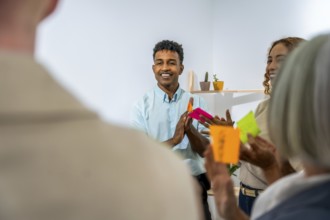 Diverse business people actively participating in a creative brainstorming session, discussing new