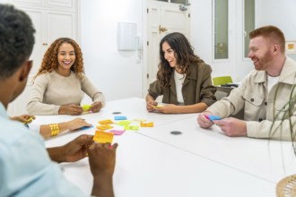 Multicultural colleagues collaborating in a modern office workshop, arranging colorful sticky notes