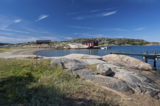 Falun red or Swedish red boathouse in a small bay, Resö island, Bohuslän, Skagerrak, Sotenäs,