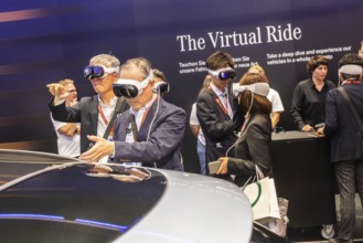 Mercedes trade fair stand with virtual presentation. Trade fair visitors with 3D glasses. The