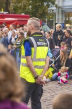 A security guard monitors an event with many spectators, Feuernacht, Sindelfingen, Germany