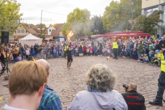Artist performs a fire show in front of a large crowd at a city festival, Feuernacht, Sindelfingen,