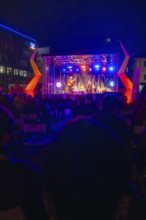 Concert at night on a colourfully illuminated open-air stage with audience, Feuernacht,
