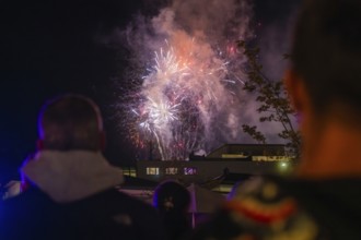 People watching fireworks in the night sky with smoke, Fire Night, Sindelfingen, Germany