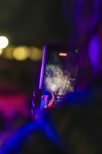 Person films fireworks with smartphone at night, Fire Night, Sindelfingen, Germany