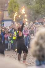 An artist performs a show with fire torches in front of a curious crowd, Feuernacht, Sindelfingen,