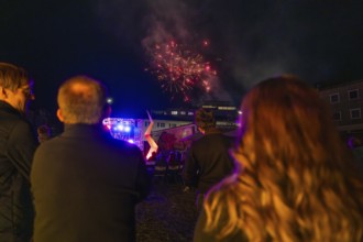 Spectators watching fireworks over an illuminated stage, nocturnal celebration, fire night,