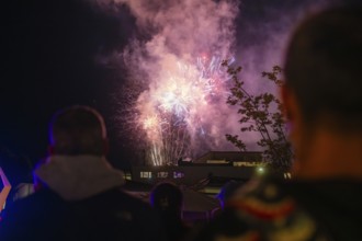 A spectacular firework display unfolds in the night sky while spectators watch, Fire Night,