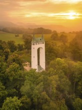 A tower rises out of a forest at golden sunset, Schönberg Tower, Pfullingen, Swabian Alb, Germany