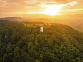 A white tower stands in a forest at sunset in the soft light, Schönbergturm, Pfullingen, Swabian