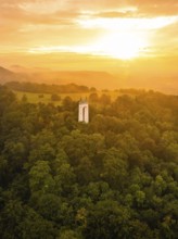 Tower in the middle of a forest under an orange-coloured sky at sunset, Schönberg Tower,