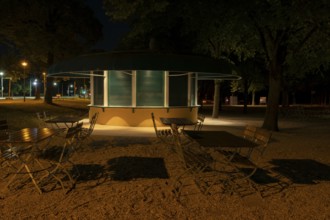 Night shot of a closed kiosk with seating in the Herrenhausen Gardens, Herrenhausen, Hanover, Lower